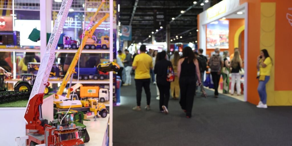 Caminhões de bombeiro e guindastes de brinquedo expostos em feira