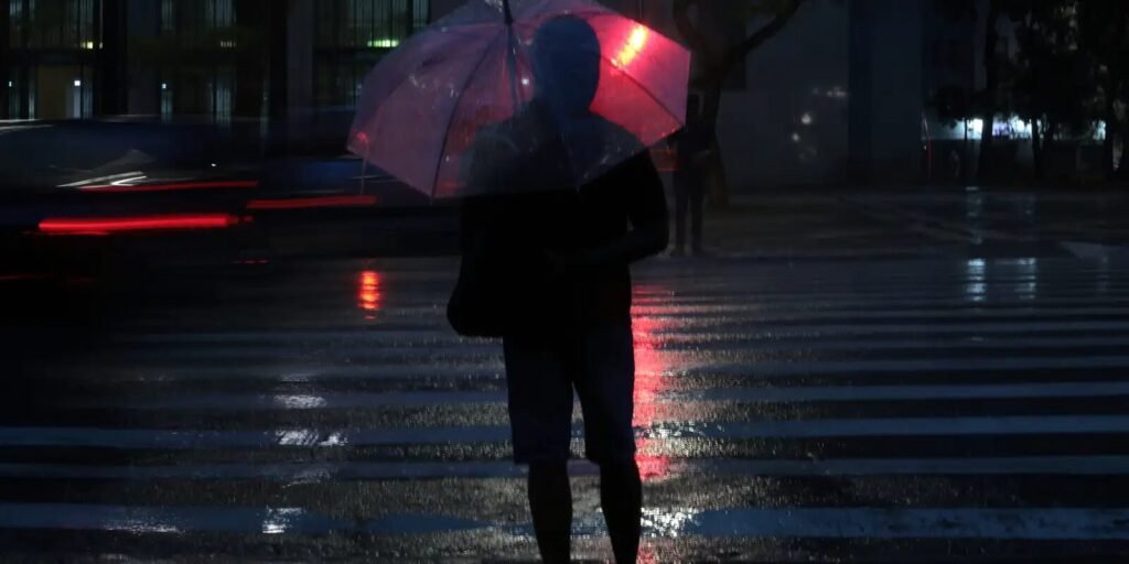 Pessoas usam guarda-chuva durante chuva no centro de São Paulo