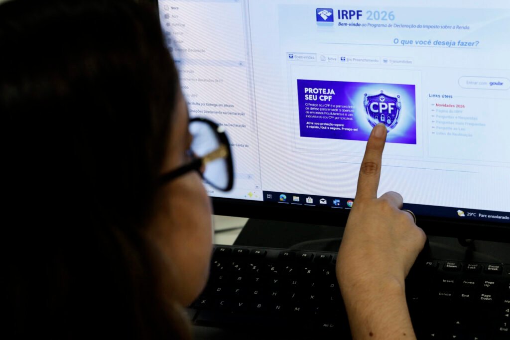 Pessoa aponta para a tela do computador com o programa do IRPF 2026